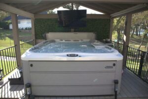 A grey hot tub under a gazebo hot tub enclosure