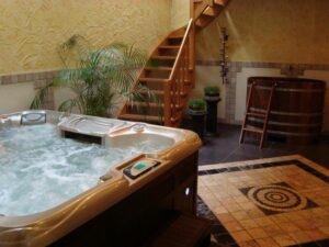 An Indoor Hot Tub Enclosure - A Small Hot Tub In A Room Of A House With Stairs And Plants