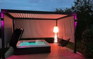 a hot tub at night with three retractable screens as a hot tub enclosure