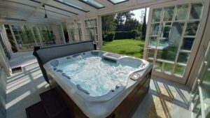 a large sunroom as a hot tub enclosure with a hot tub inside