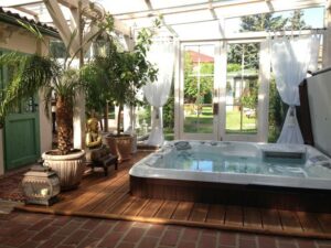 An Inground Hot Tub In A Small Outdoor Hot Tub Enclosure